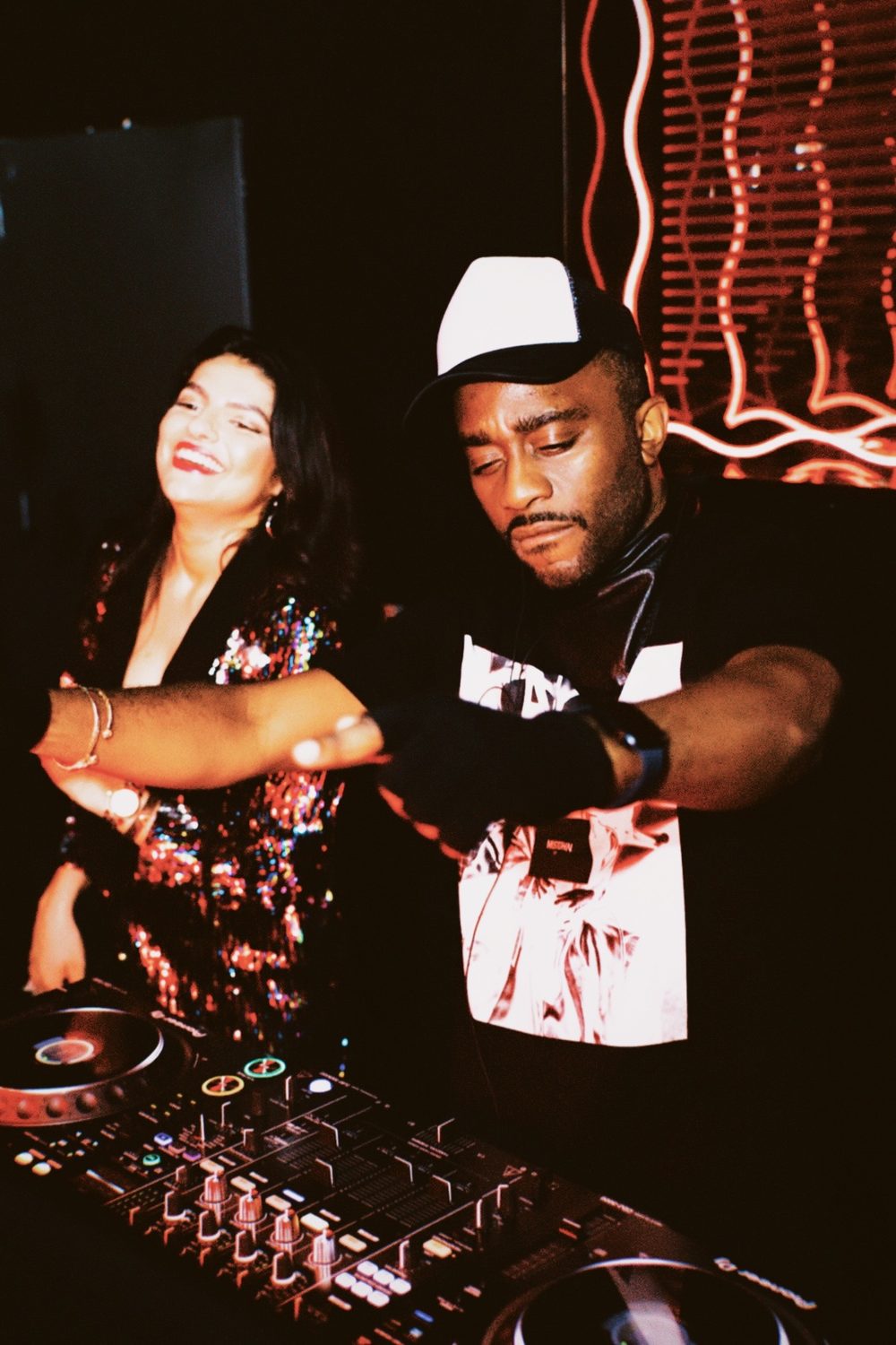 A DJ set, crowd nearby