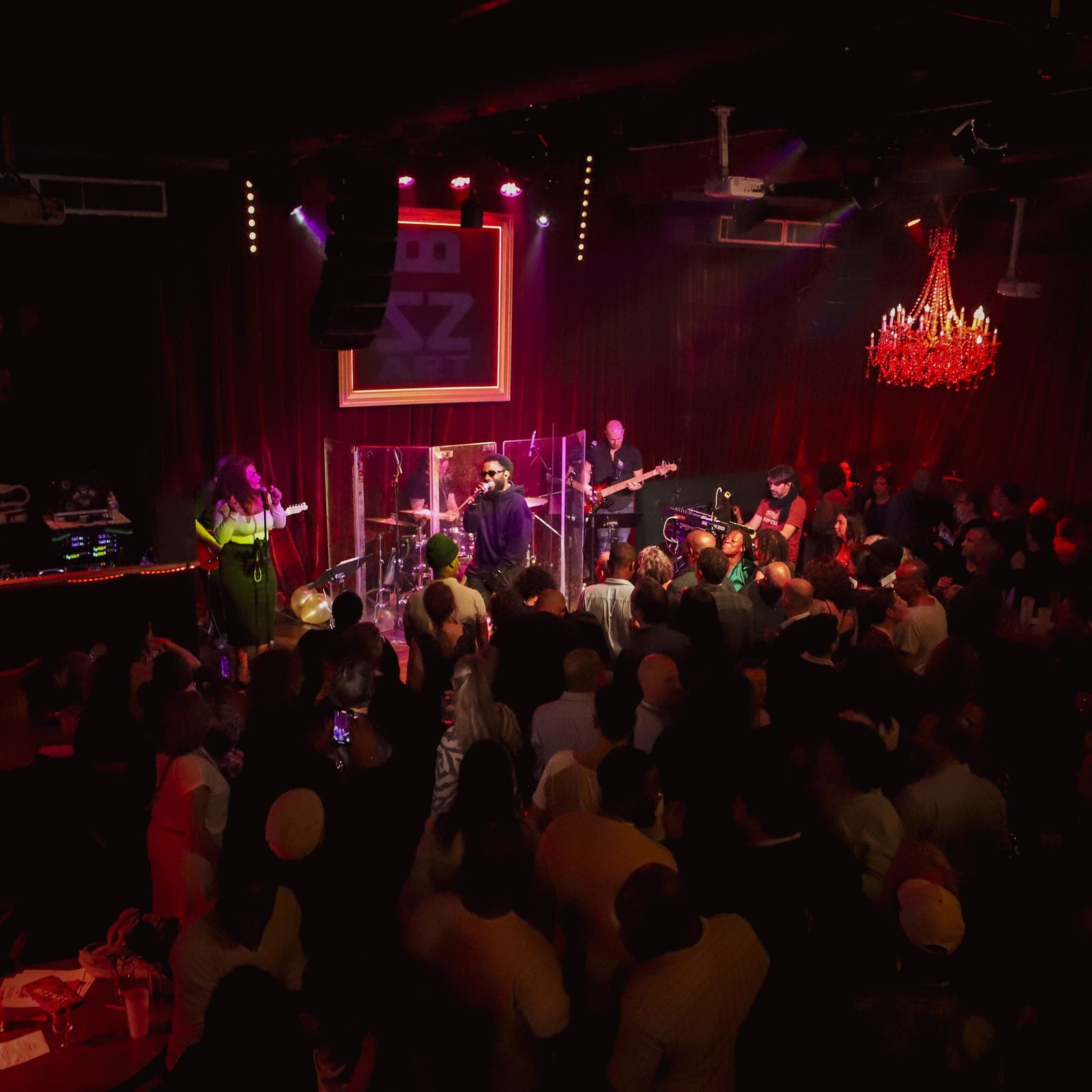 A live band in a red-lit room