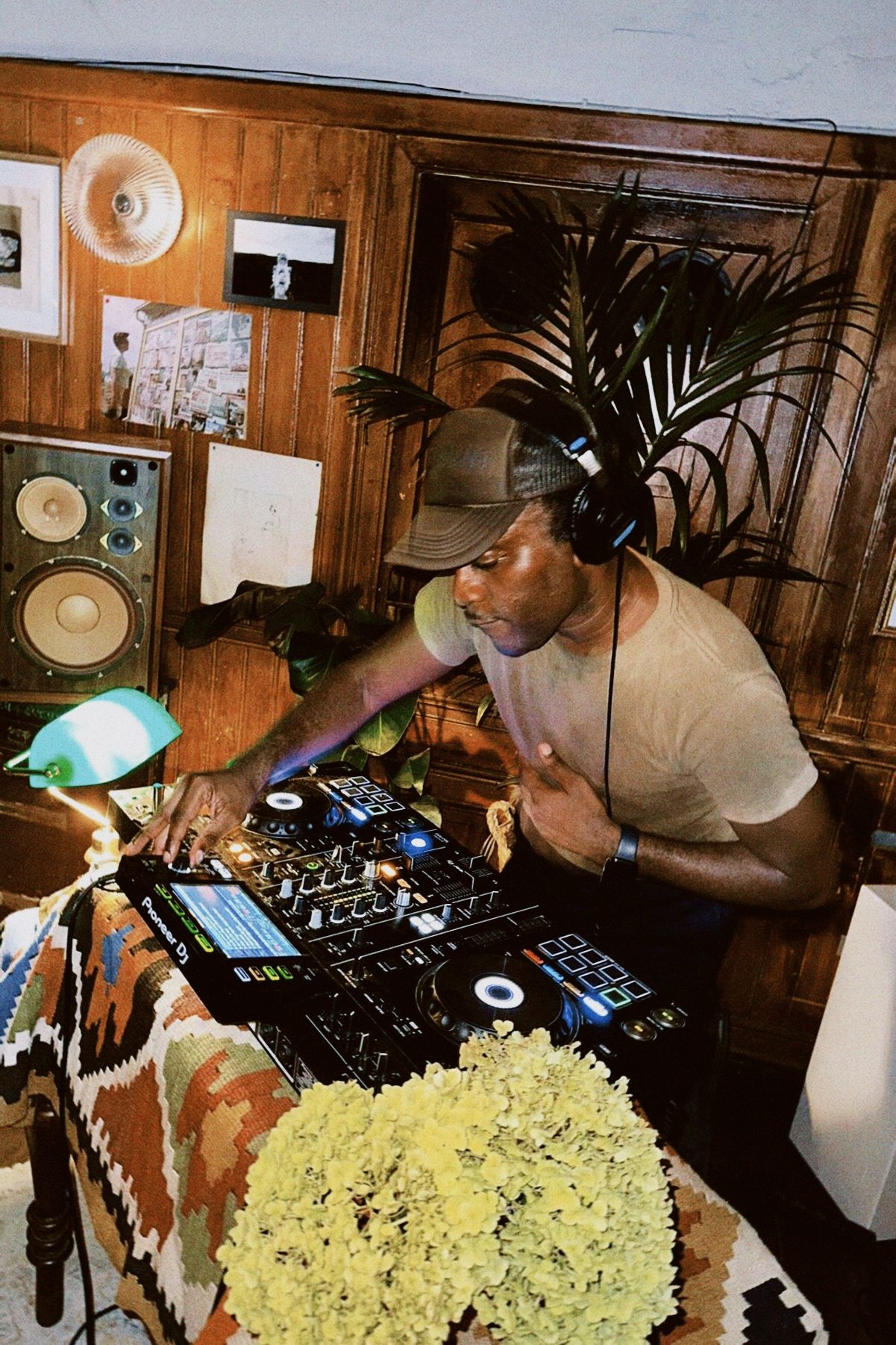 Chris Stylez at the decks in a wood-panelled room