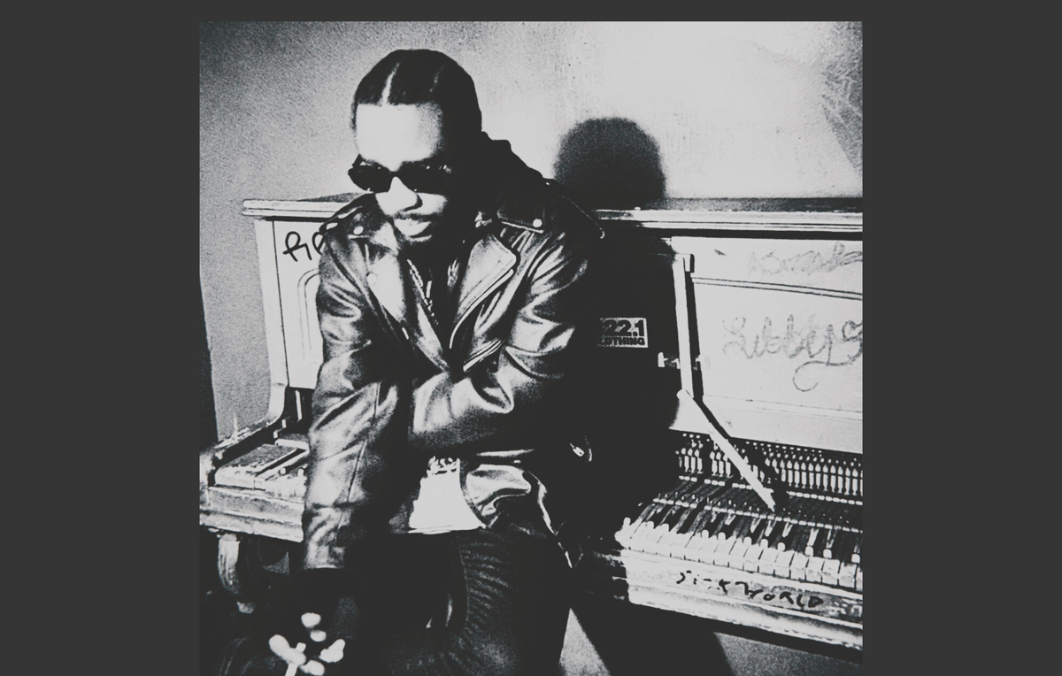 Chris Stylez seated at a piano