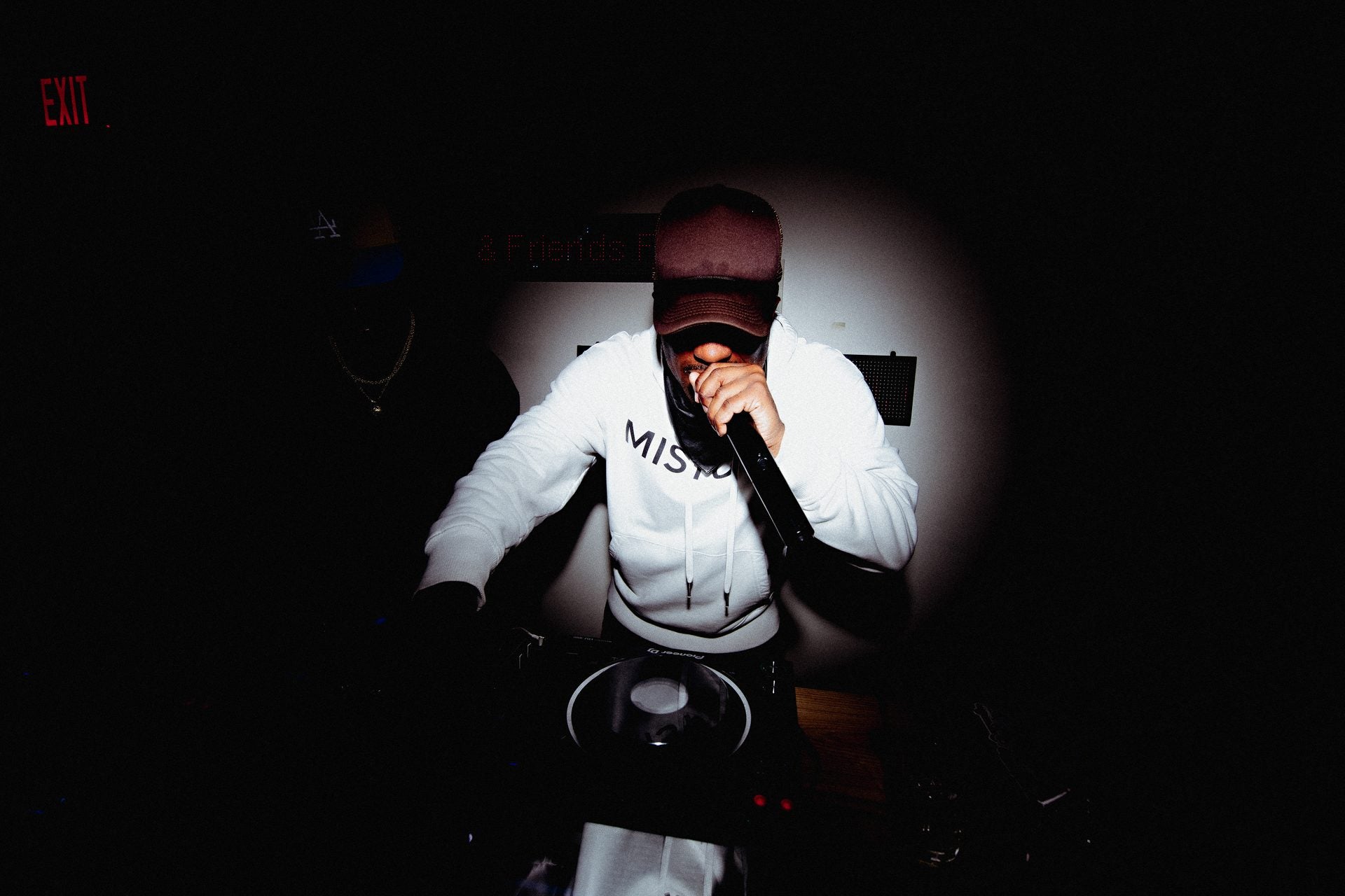Chris Stylez performing, mic in hand